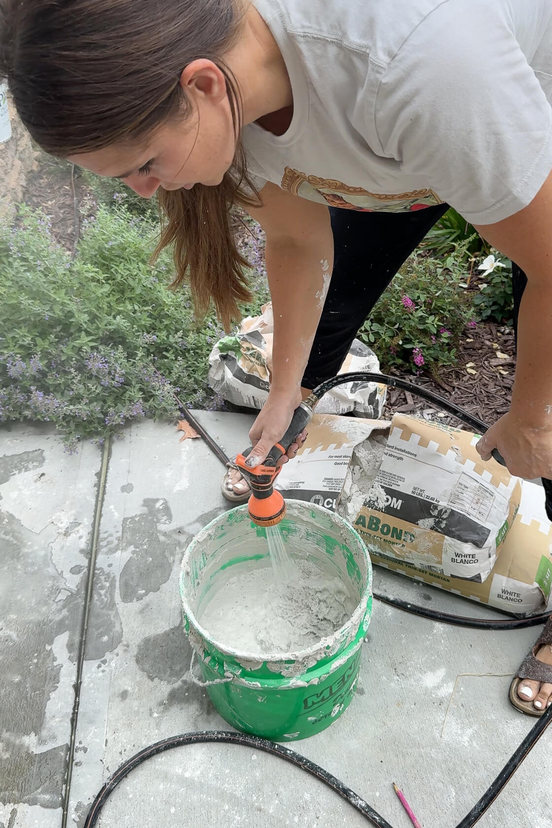 Mixing mortar to update a 1970s exterior rock wall.